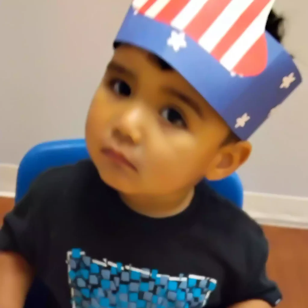 Child wearing American flag paper crown at Pinebrook Montessori