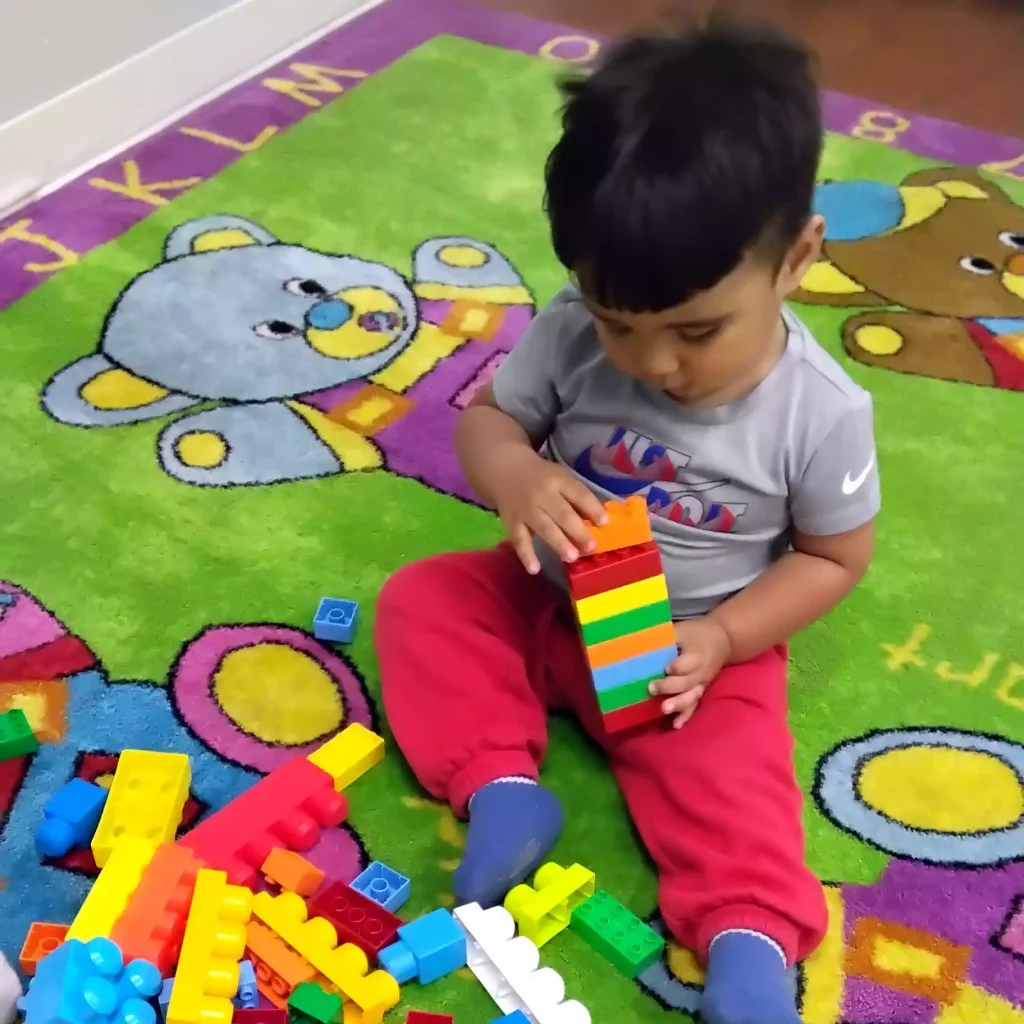 Child building with large blocks at Pinebrook Montessori
