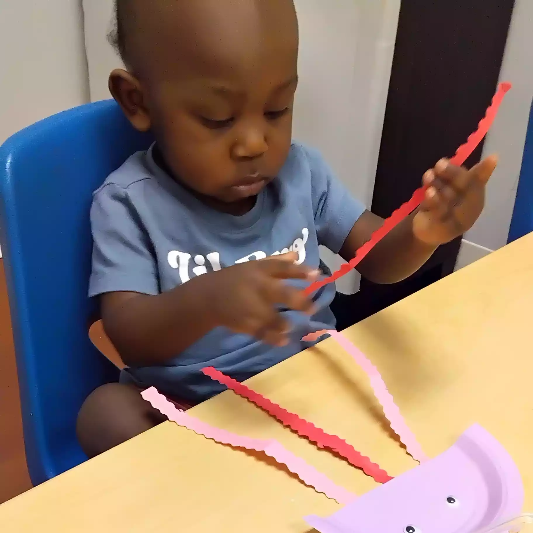 Pinebrook Pre-K Student Working on Paper Jellyfish Craft - Pinebrook- Preschool - Pinebrook- Preschool Toddler making jellyfish craft at Pinebrook Montessori