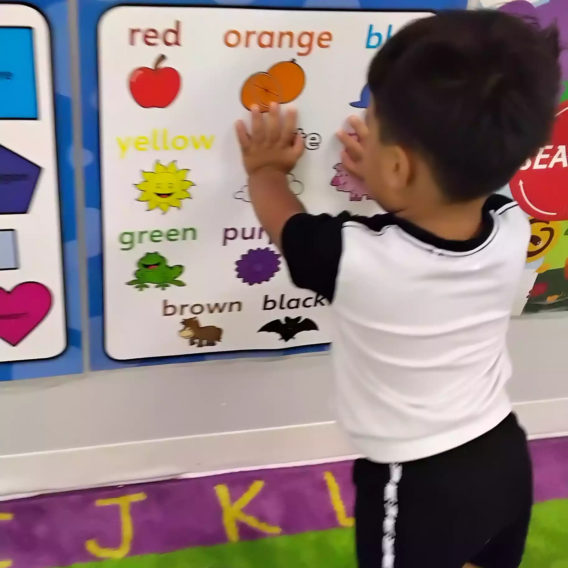 Pinebrook Pre-K Student Exploring Colors Wall Poster - Pinebrook- Preschool - Pinebrook- Preschool Pinebrook Montessori student exploring classroom color chart